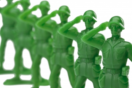 Close up image of a green military miniatures on a salute gestures against white backgroundの写真素材