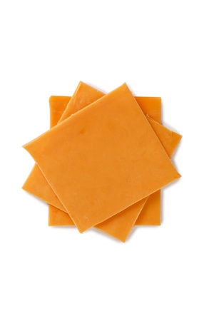 Close-up image of slices of cheddar cheese in a white backgroundの写真素材