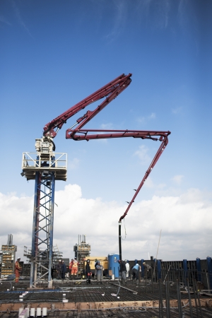 Construction crane at construction site with blue sky in the background.のeditorial素材
