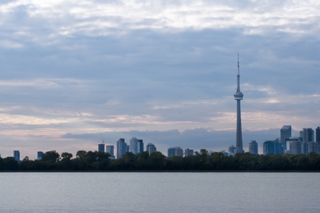 Long distant shot of cityscape with sea in foreground.の写真素材