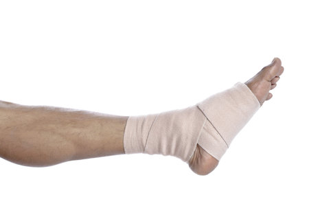 Close up image of man's foot with a tensor bandage against a white background