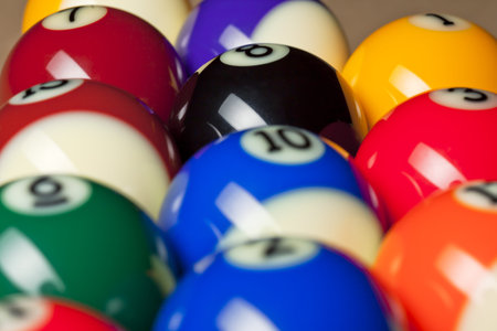 A portrait close up of different colors and numbers of a billiard ball