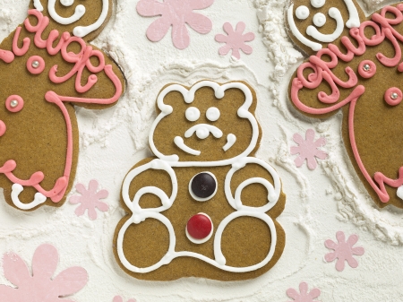 Yummy gingerbread cookies lying on flour decorated with flowersの写真素材