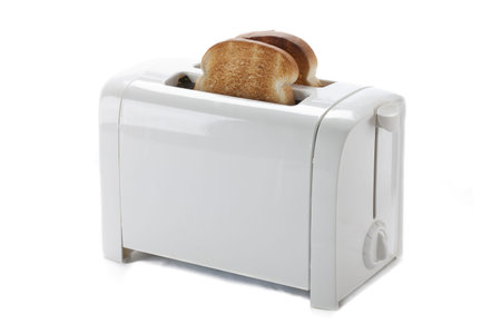 Toasted bread in a toaster isolated on white.