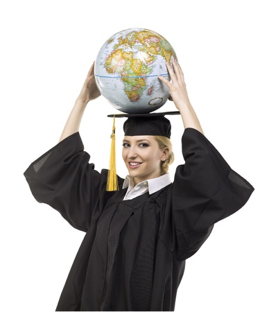 Adorable female graduate holding a globe over her headの写真素材