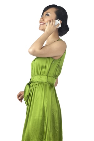 Calling Asian woman isolated in a white backgroundの写真素材
