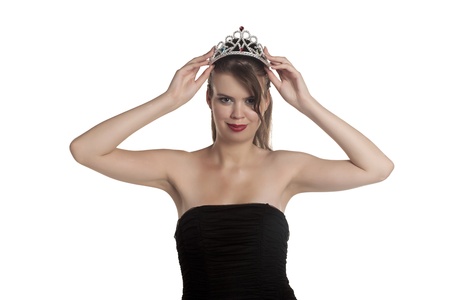 Attractive teenager with crown on her head isolated on a white backgroundの写真素材