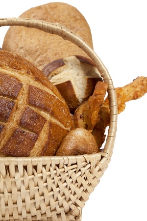 Cropped image of the basket with an assortment of bread lying on a white backgroundの写真素材