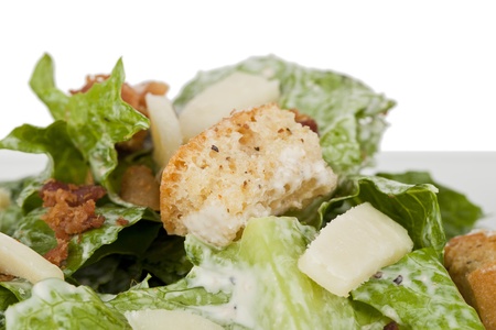 Close-up image of Caesar salad dressed croutons and cheese against the white surfaceの写真素材
