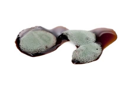 Liquid caramel with mold isolated on a white backgroundの写真素材