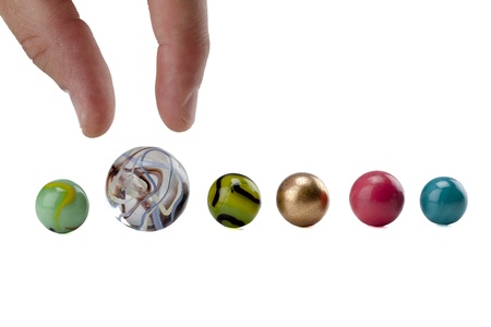 Image of human hand picking big marble against white backgroundの写真素材