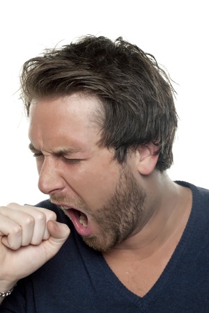 Close up portrait of sleepy man yawning against white backgroundの写真素材