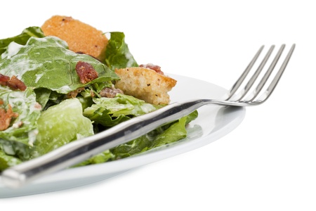 Close up image of tasty ceasar salad in plate against white backgroundの写真素材