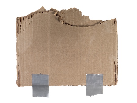 Close up image of torn sheet of brown cardboard against white backgroundの写真素材