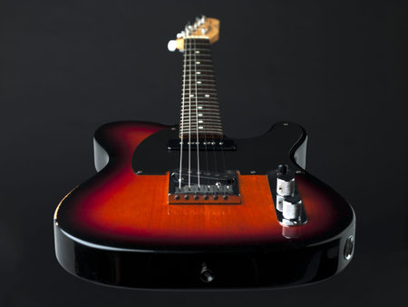 Wooden electric guitar in a full length image