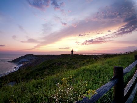 Image of a lighthouse during sunset with sky in the background.の写真素材