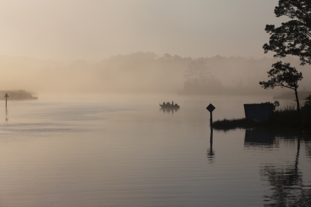 Some fishermen attempt to catch some fish during sunrise.の写真素材