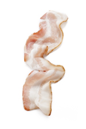 Close-up of sliced raw bacon isolated on white background.の写真素材