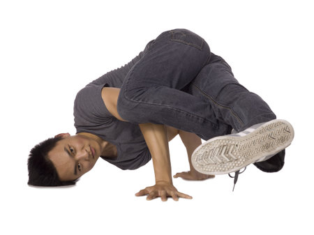 Close up shot of a teenage break dancer performing a stance over a white background