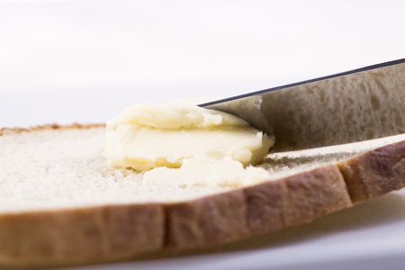 Close-up image a slice of bread with a creamy butter spreadの写真素材