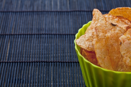 Cropped bowl of spicy flavored potato chipsの写真素材