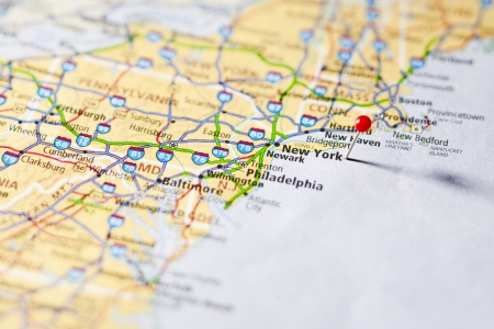 Close-up of image of red pin on New York in the world mapの写真素材