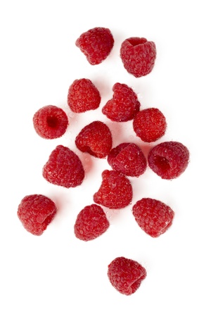 Top view shot of juicy raspberries scattered in a white backgroundの写真素材