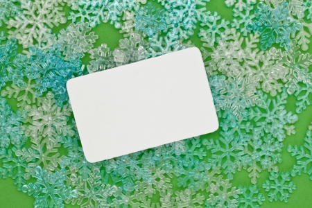 Close-up image of a Christmas card and snowflakes in the green backgroundの写真素材