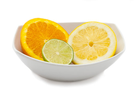 A lime, orange and lemon sliced and placed in dish.