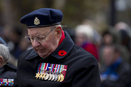 Close-up shot of a senior citizen in military uniform and medal.