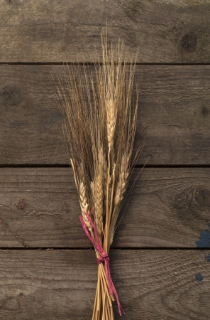 Image of bundle of wheat on wooden tableの写真素材