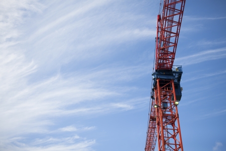 Low angle view of a construction crane with blue sky in the background.の写真素材