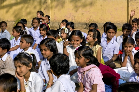 A group of children sit  providing an aray of different looksのeditorial素材