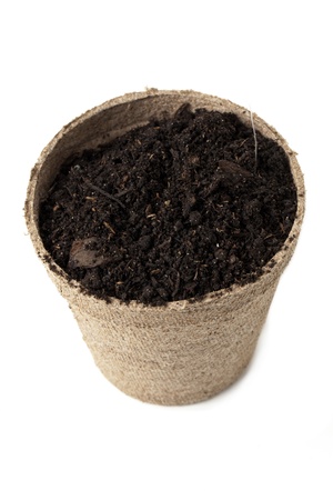 Close up image of pot with ground soil against white backgroundの写真素材