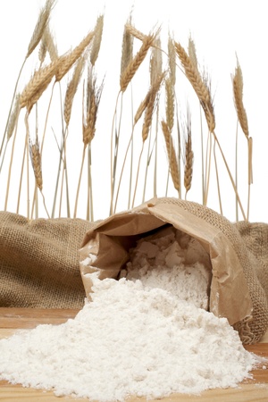 Spilled sack of flour and wheat earsの写真素材