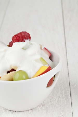 Cropped image of bowl of fruit salad on wooden tableの写真素材