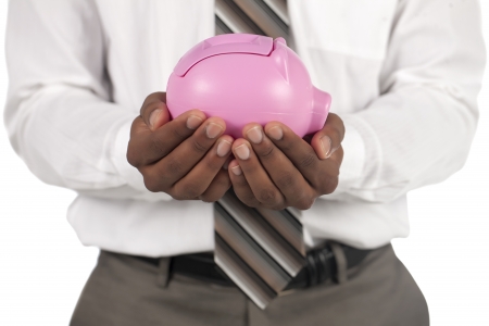 Banking concept represented by businessman holding a piggy bankの写真素材