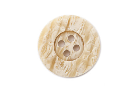 Close up image of button made of ivory against white background