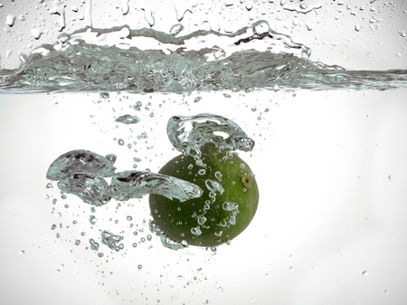 Image of a fresh lime fruit under the clear waterの写真素材