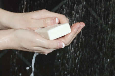 Close up shot of a female's hands washing with soapの写真素材