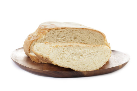 Sliced bread loaf on a wooden plate