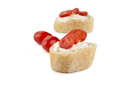 Close-up image of slices of bread with melted butter and fresh tomatoesの写真素材