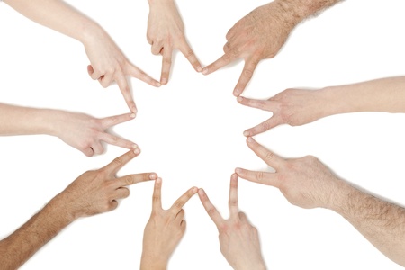 Close-up image of a group of hands connecting with a peace sign over the white backgroundの写真素材