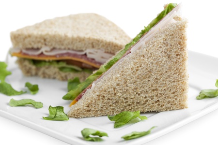Image of slices of ham sandwich in white plateの写真素材