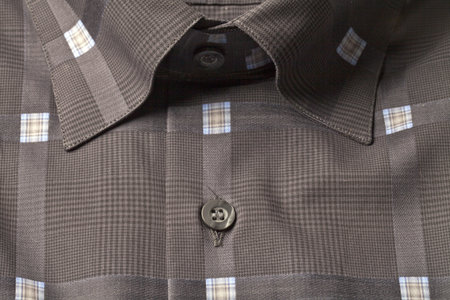 Cropped image of a folded brown polo shirt