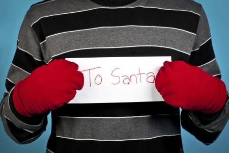 Cropped image of a man holding a letter against turquoise backgroundの写真素材