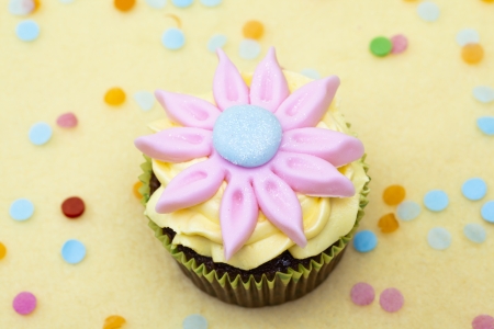 Close-up of a cupcake with a floral pattern cream.の写真素材