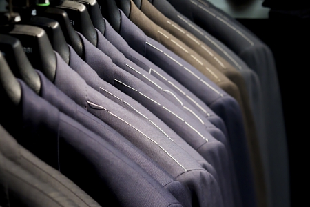 Close-up of suits on clothes rack.の写真素材