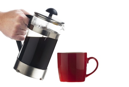 Red mug and coffee pot in a close-up imageの写真素材