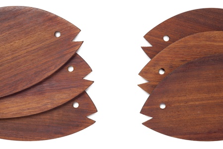 Set of wooden fishes decor arranged over a white backgroundの写真素材